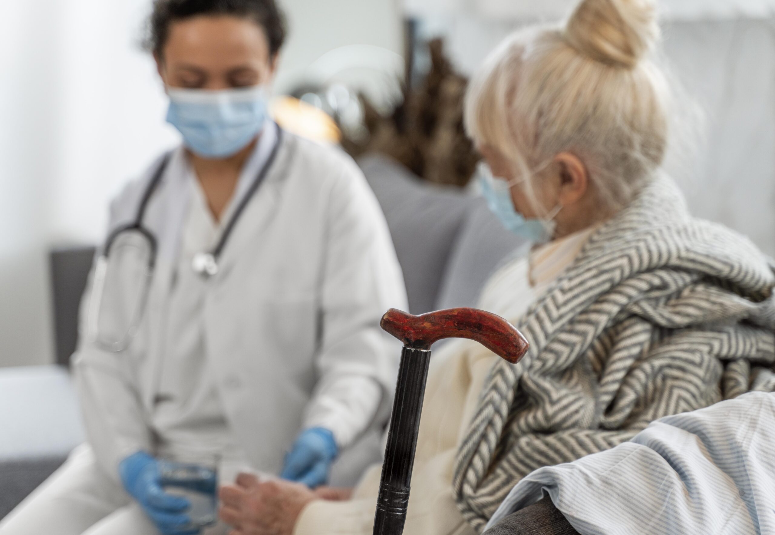 Health professional talking to older woman